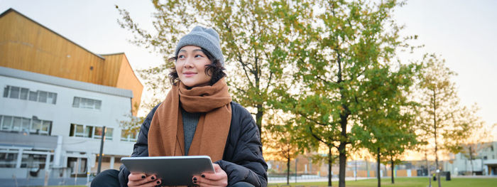 Portrait of woman using digital tablet