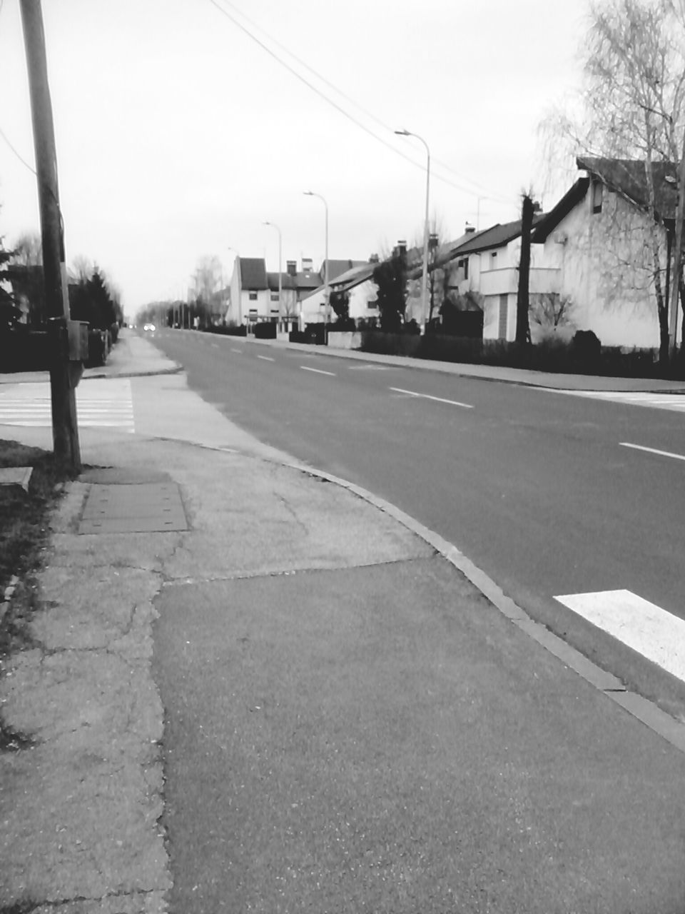 transportation, the way forward, road, diminishing perspective, street, vanishing point, road marking, clear sky, asphalt, sky, tree, long, building exterior, empty road, built structure, car, empty, architecture, country road, day