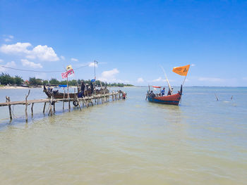 People on beach against sky