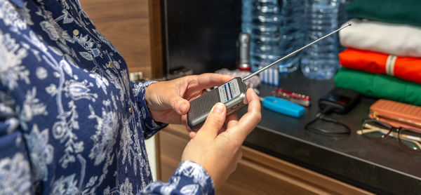 Midsection of woman using mobile phone