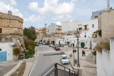 Street amidst buildings in city against sky