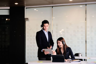 Young woman using mobile phone in office