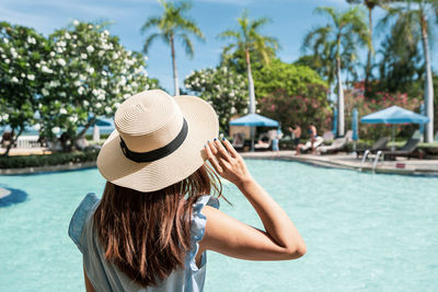 Rear view of woman wearing hat in swimming pool