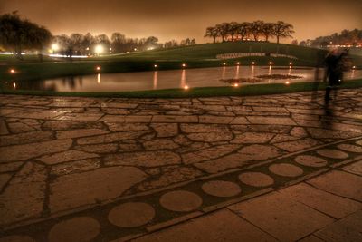 Illuminated lamp post at night