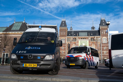 Cars on street against buildings in city