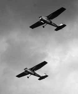 Low angle view of airplanes flying in sky