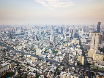 High angle view of city buildings against sky