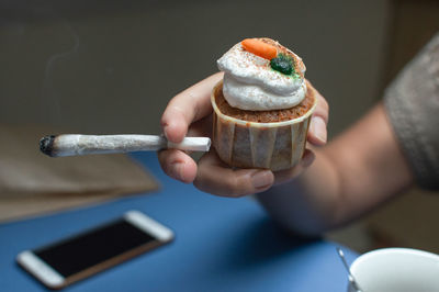 Close-up of hand holding ice cream