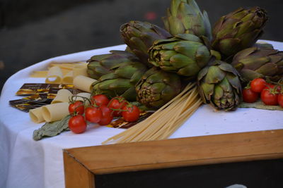 Artichokes and tomatoes on table