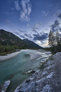 Scenic view of river against sky during winter