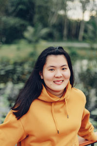 Portrait of young woman standing outdoors