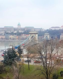 Bridge over river with city in background