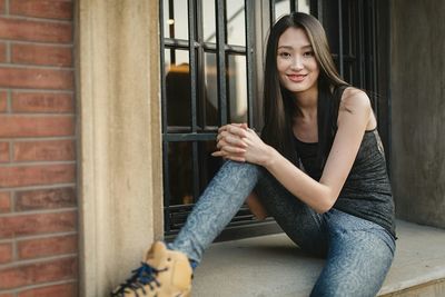 Portrait of young woman sitting at home