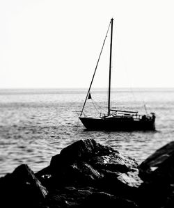 Sailboat on sea against clear sky