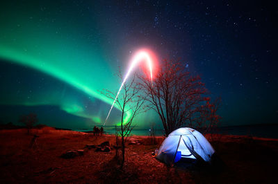 Scenic view of landscape against sky at night