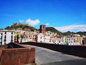 View of the colourful town of bosa in sardinia with the hilltop castle of serravalle