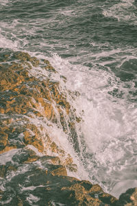 High angle view of waves rushing towards shore