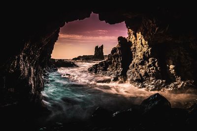 Scenic view of sunset over sea seen from tunnel