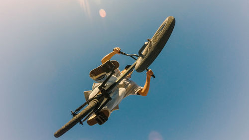 Low angle view of cross against clear blue sky