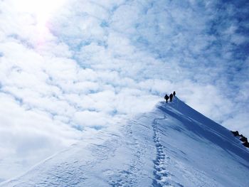 Low angle view of people hiking on mountain