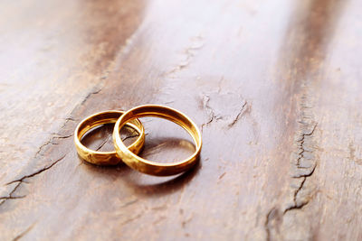 Close-up of wedding rings on table