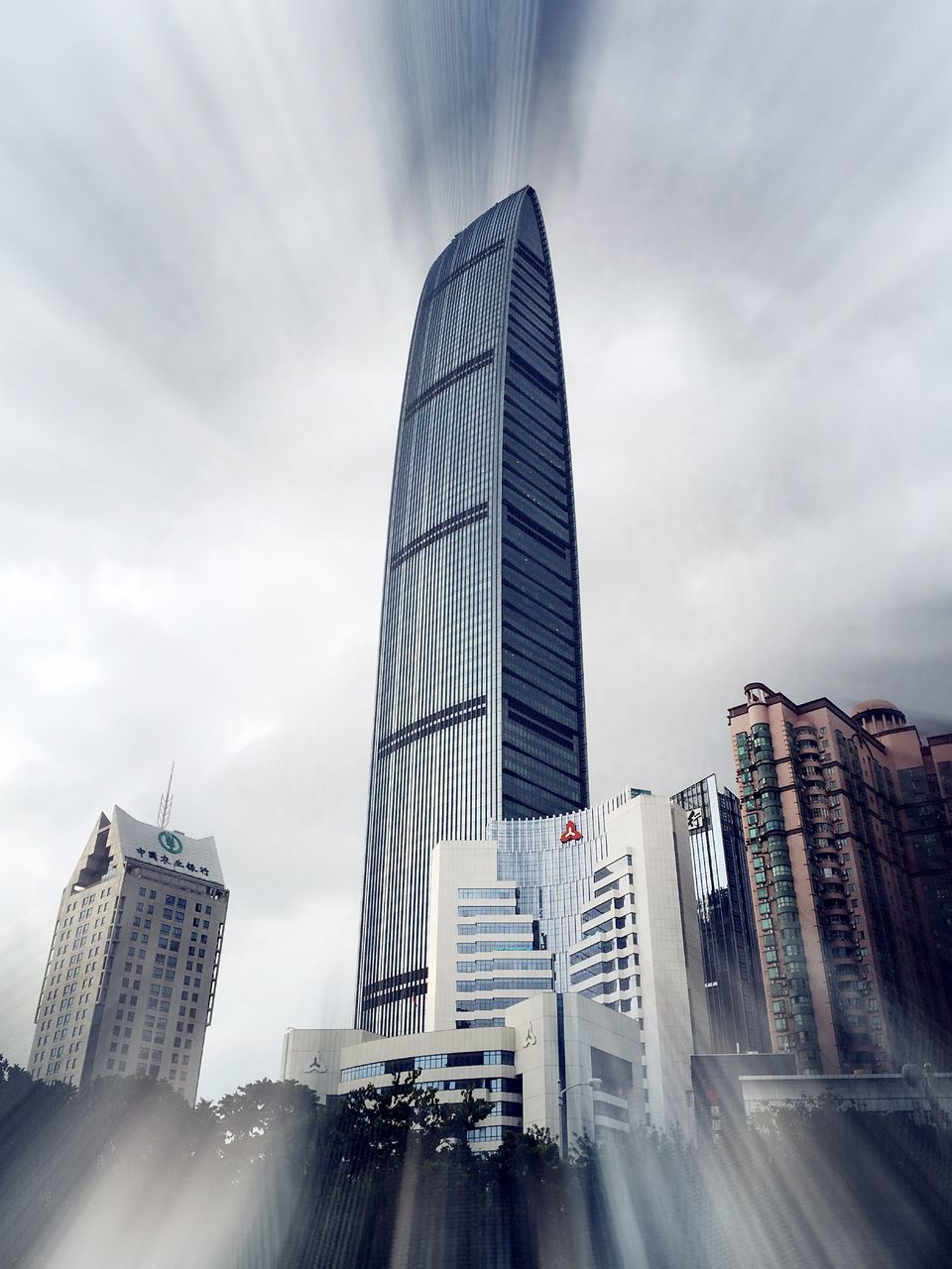 architecture, building exterior, modern, built structure, skyscraper, city, office building, tall - high, low angle view, sky, tower, cloud - sky, building, capital cities, financial district, city life, day, outdoors, cloud, tall, travel destinations, cloudy, development, no people, office block, sunbeam