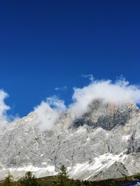 Low angle view of snowcapped mountain against sky