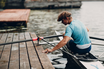 Side view of man working at harbor