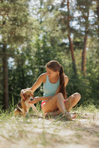 Portrait of young woman sitting on field