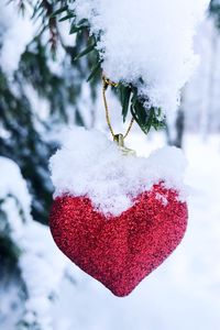 Close-up of frozen red heart shape in winter
