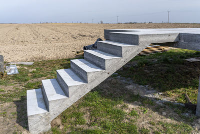 Concrete rectangular structure on concrete poles with stairs in raw condition.