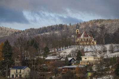 Buildings in town against sky