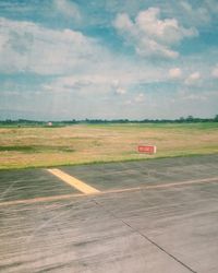 Airplane on landscape against sky