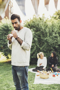 Portrait of man drinking elderflower drink at rooftop party