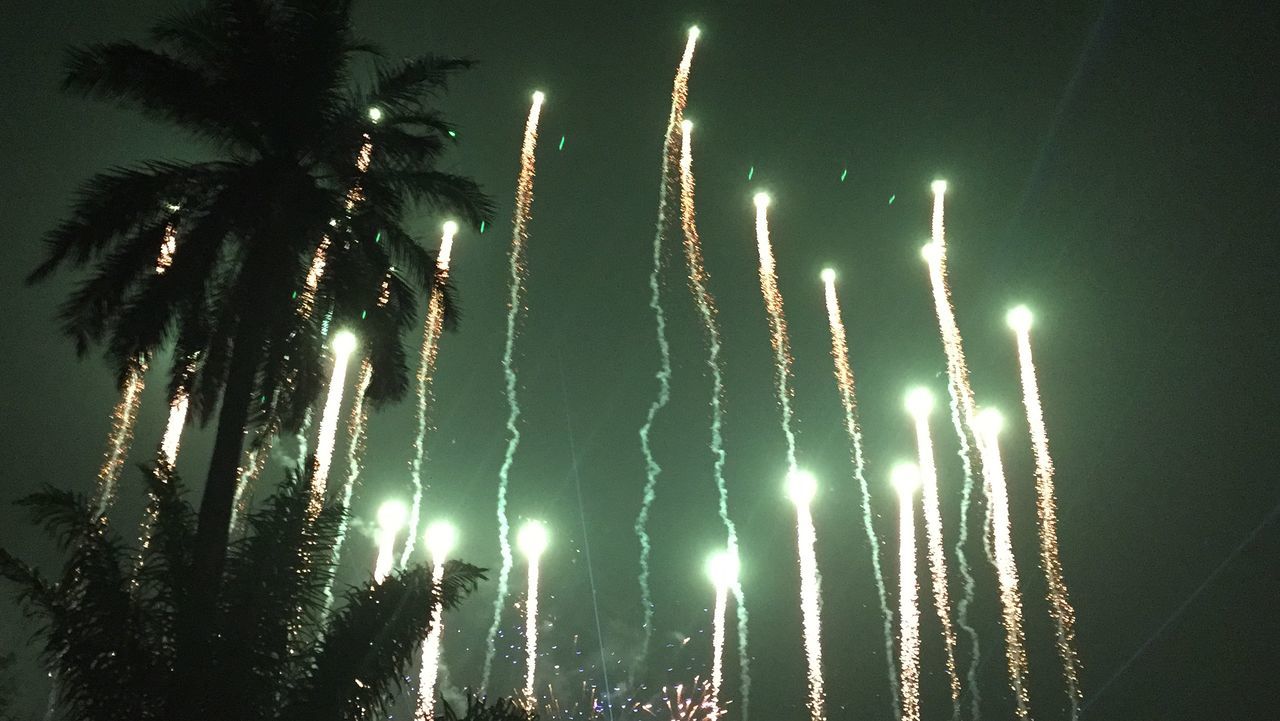 night, illuminated, celebration, firework display, glowing, low angle view, exploding, long exposure, firework - man made object, firework, sky, motion, sparks, light - natural phenomenon, event, arts culture and entertainment, outdoors, no people, light, lighting equipment