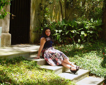 Portrait of a smiling young woman sitting outdoors