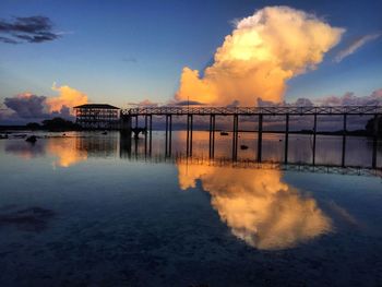 View of pier over sea against sky during sunset