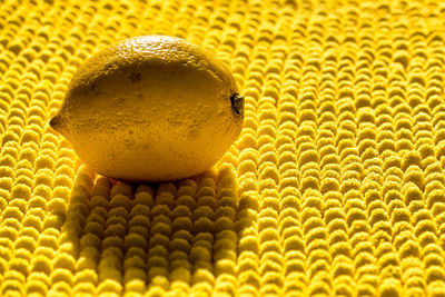 Close-up of lemon on yellow fabric