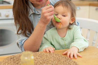 Midsection of girl playing with toy at home