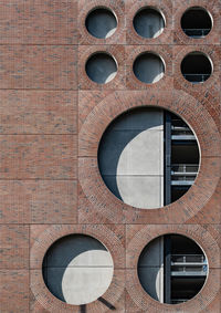 Low angle view of circles on brick building