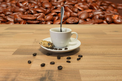 Close-up of coffee beans in glass on table