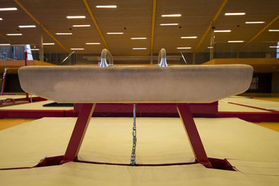 Empty chairs and tables in illuminated room