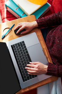 Midsection of woman using laptop