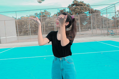 Full length of young woman in swimming pool