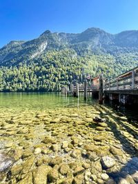 Scenic view of lake and mountains against blue sky