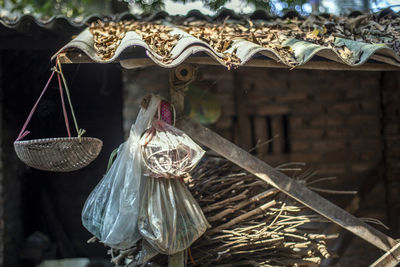 Close-up of wicker basket hanging from roof