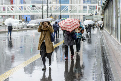 People walking in rain on rainy day