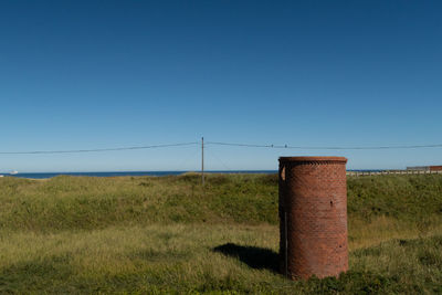 Scenic view of field against clear blue sky