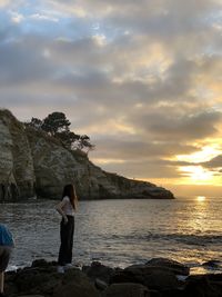 Scenic view of woman staring out to sea against sky during sunset in san diego, california 