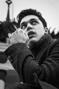 Portrait of young man looking away outdoors